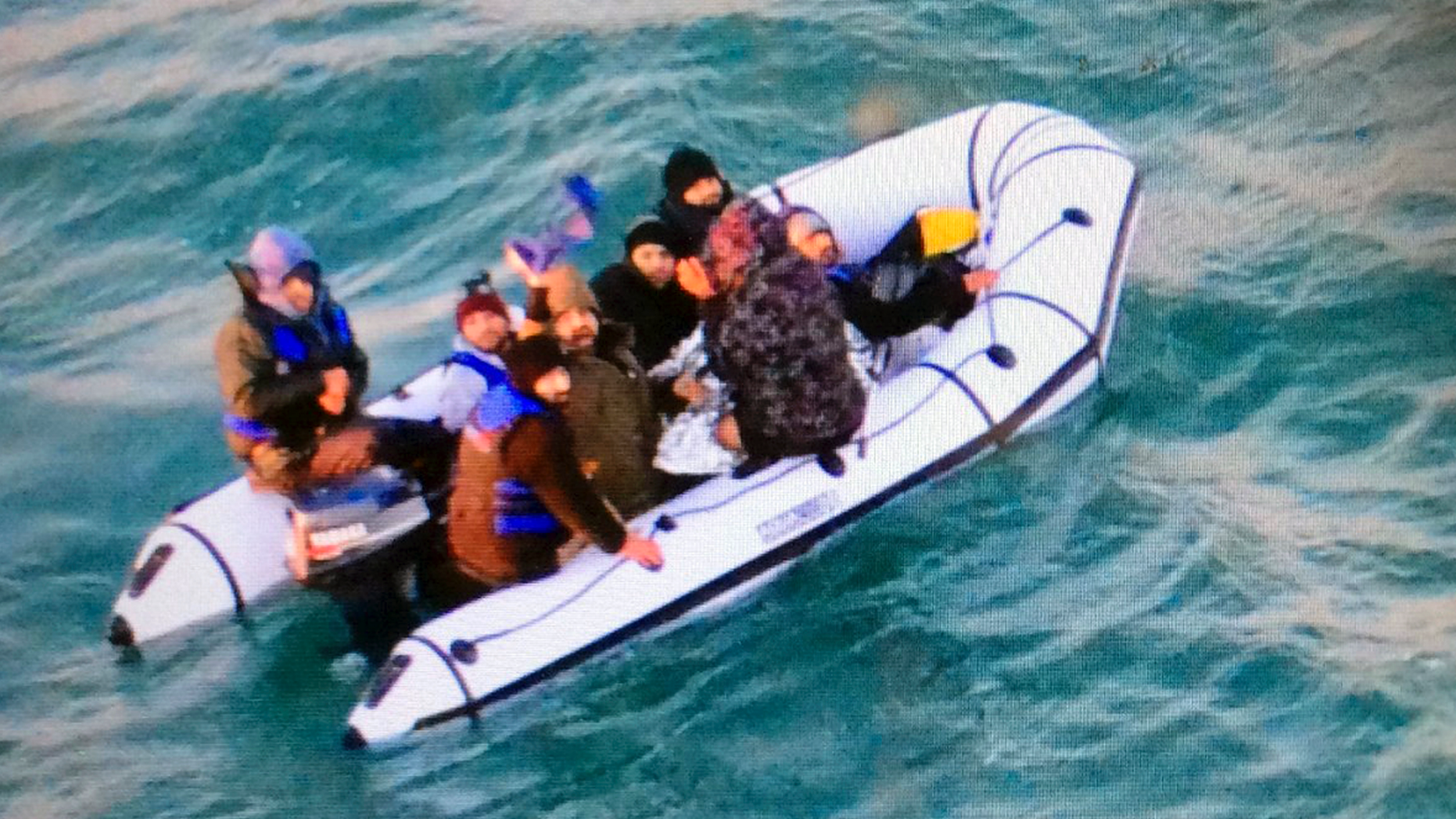 This image provided by the Marine National shows migrants aboard an inflatable boat after being intercepted by French authorities outside the port of Calais, northern France, on Tuesday, December 25, 2018. The French authorities have rescued eight migrants, including two children whose engines failed when they tried to sneak across the English Channel to the UK. (Marine Nationale via AP)